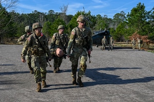Soldiers carry a training dummy in a stretcher. (U.S. Air Force photo by Airman 1st Class Donnell Ramsey)