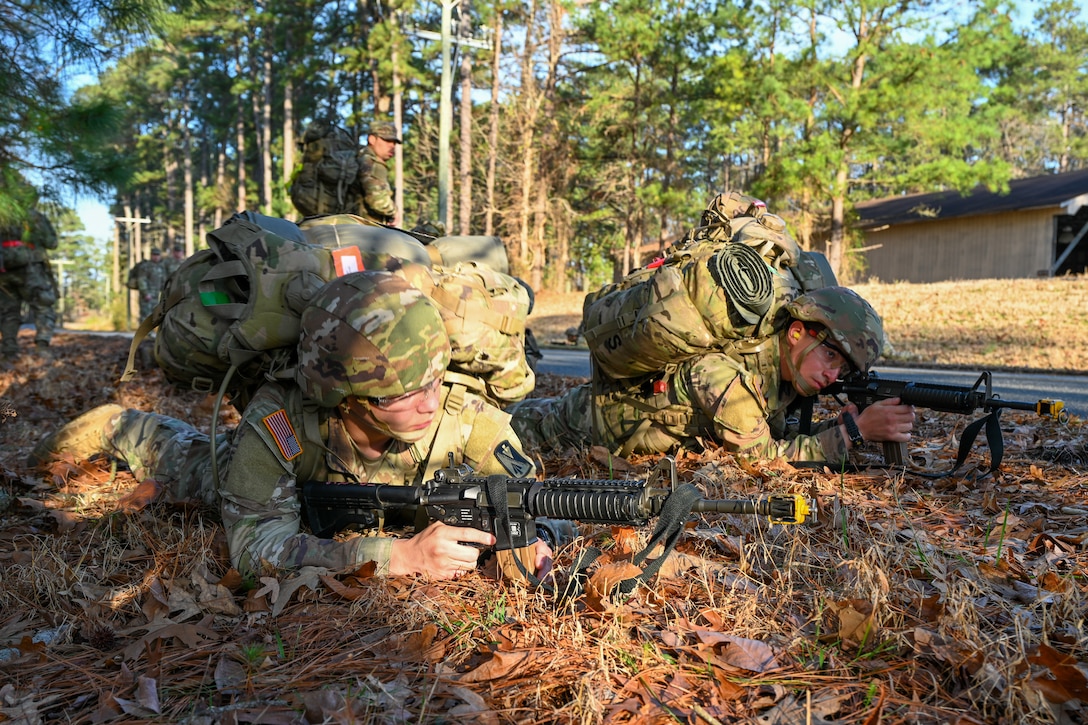 Soldiers lie on the ground armed with replica weapons. (U.S. Air Force photo by Airman 1st Class Donnell Ramsey)