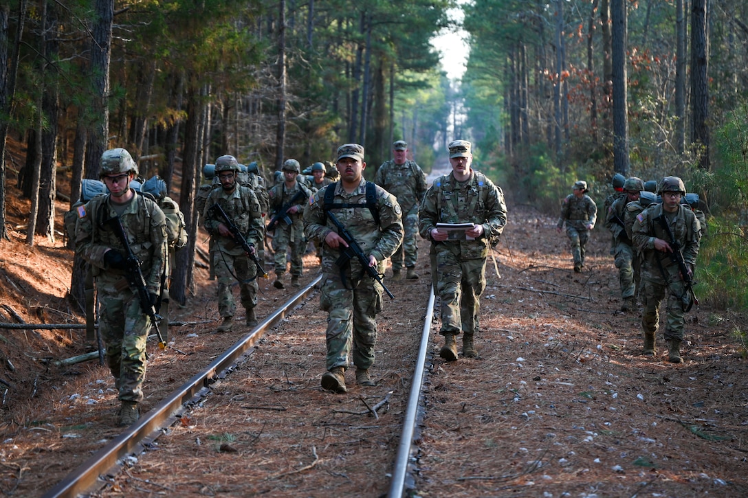 Soldiers ruck along train track. (U.S. Air Force photo by Airman 1st Class Donnell Ramsey)