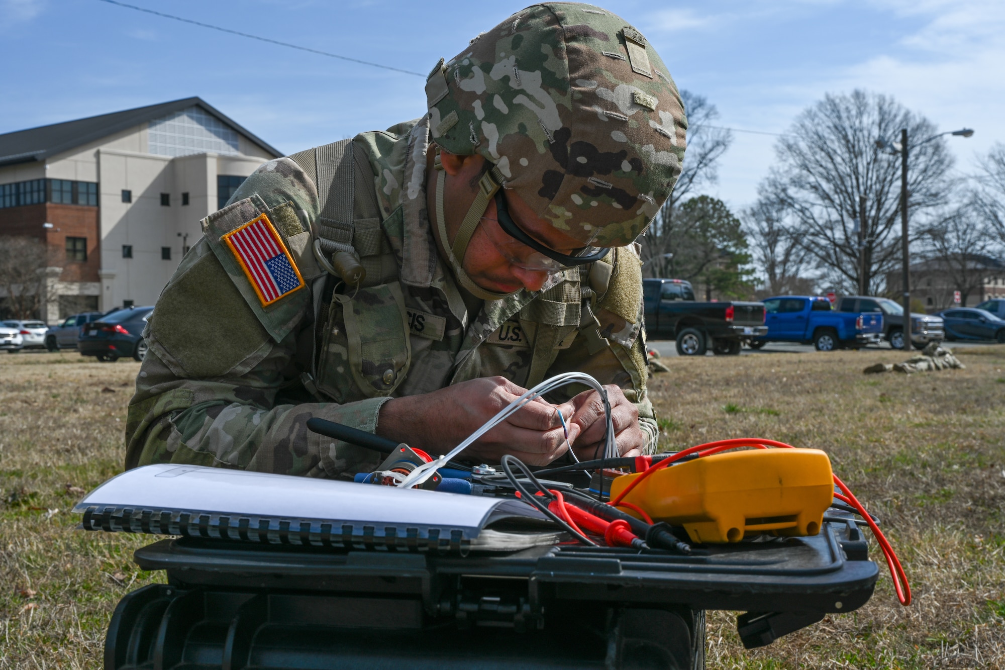 Soldier ties wires together with hands. (U.S. Air Force photo by Airman 1st Class Donnell Ramsey)