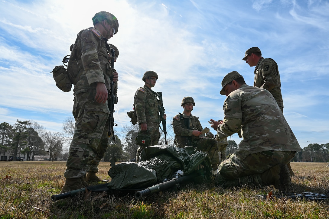 Soldiers crowd around a training dummy. (U.S. Air Force photo by Airman 1st Class Donnell Ramsey)