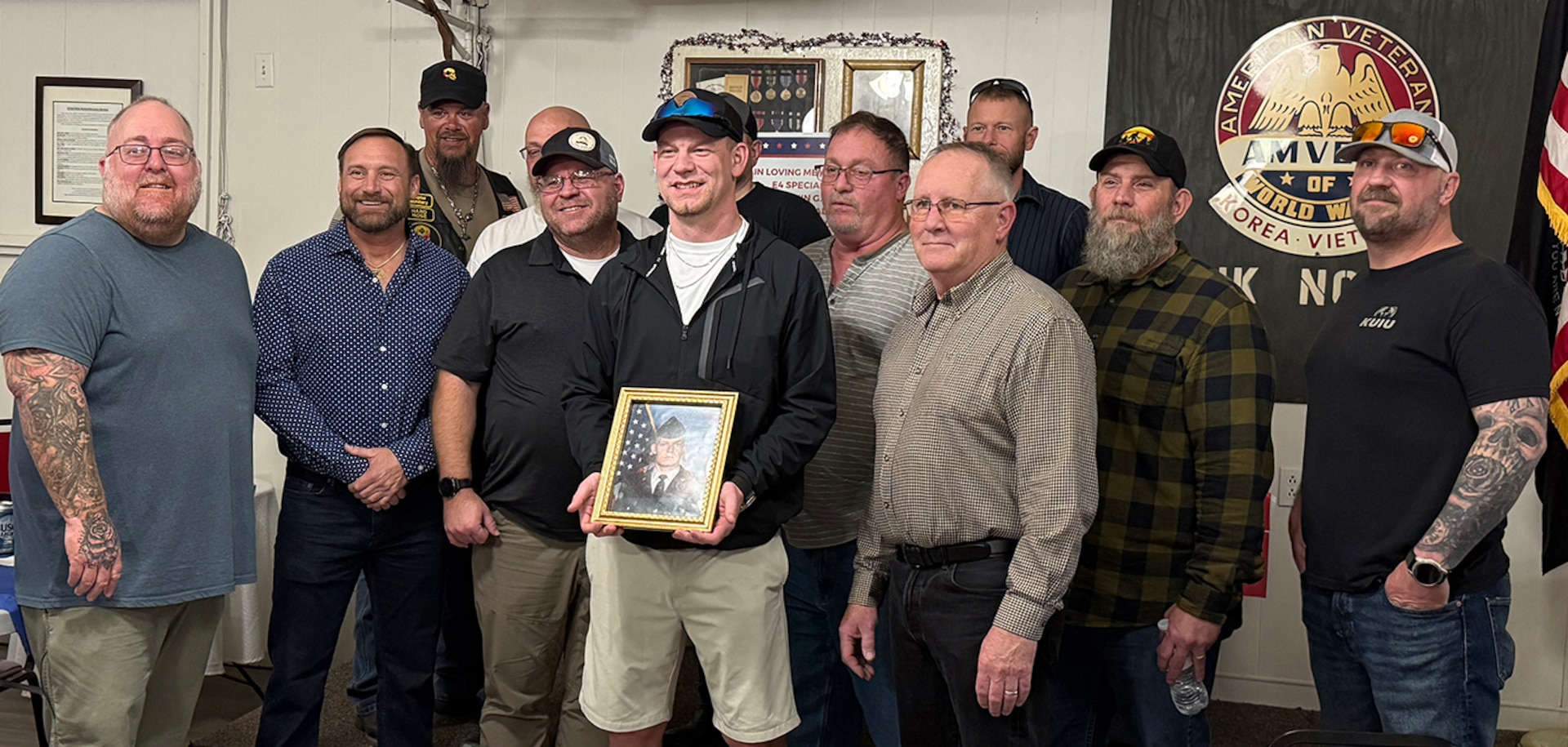 Veterans of 3rd Battalion, 123rd Field Artillery Regiment gather with Andrew Kash, son of Spc. Benjamin Kash, during a remembrance event at the Waltonville, Illinois, Veterans of Foreign Wars Post 9153 March 14.