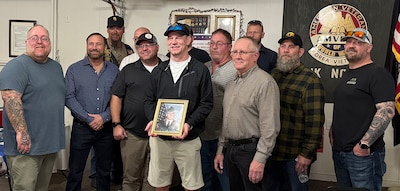 Veterans of 3rd Battalion, 123rd Field Artillery Regiment gather with Andrew Kash, son of Spc. Benjamin Kash, during a remembrance event at the Waltonville, Illinois, Veterans of Foreign Wars Post 9153 March 14.