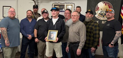 Veterans of 3rd Battalion, 123rd Field Artillery Regiment gather with Andrew Kash, son of Spc. Benjamin Kash, during a remembrance event at the Waltonville, Illinois, Veterans of Foreign Wars Post 9153 March 14.