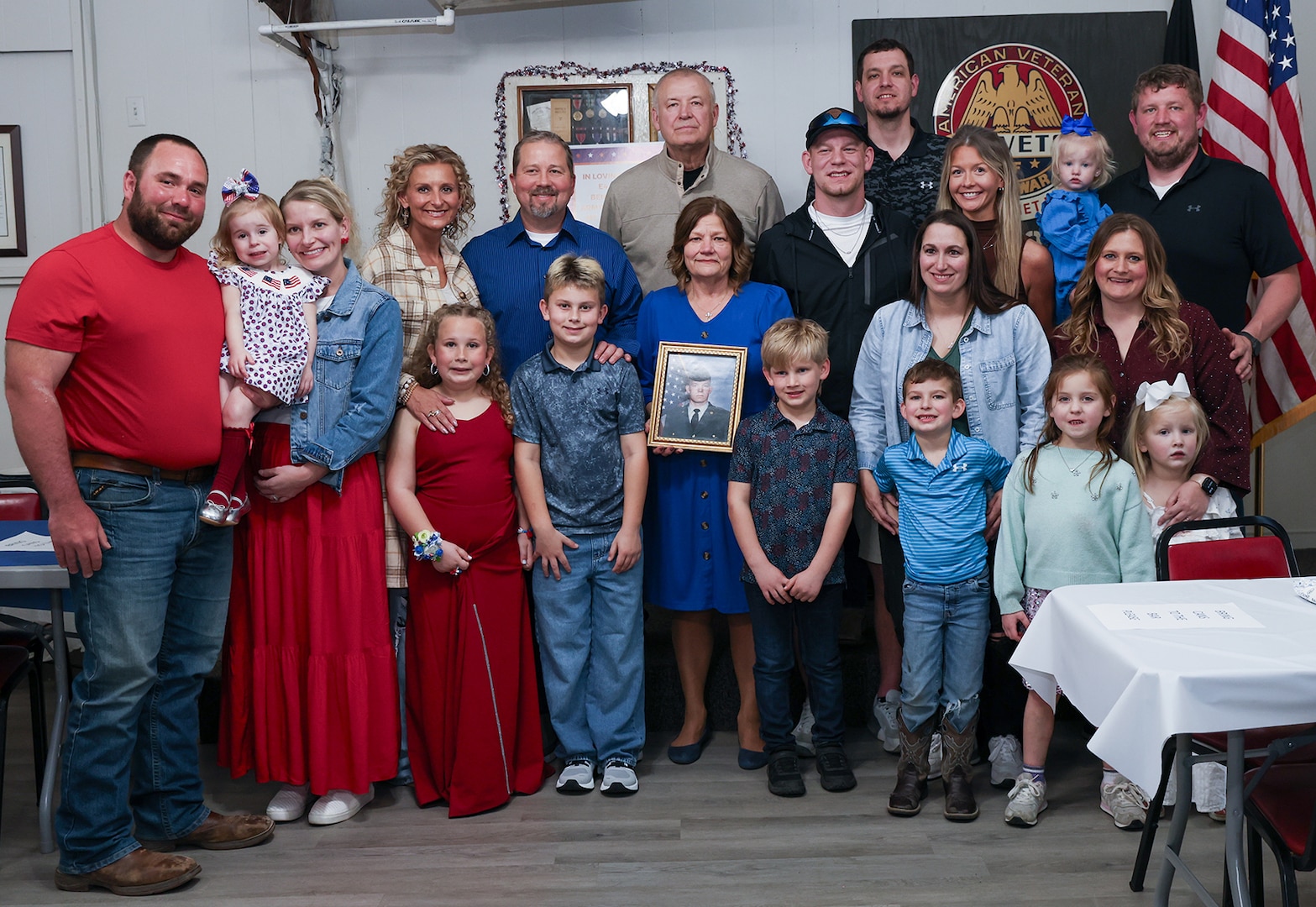 The family of Spc. Benjamin Kash, including son Andrew, gathers around his U.S. Army basic training photo during a remembrance event at Waltonville, Illinois, Veterans of Foreign Wars Post 9153 March 14.
