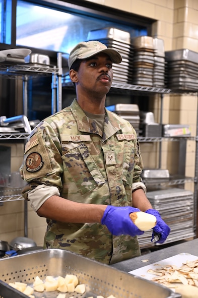 Senior Airman Jared Mack, 5th Force Support Squadron food services team member, prepares ingredients during an internal cooking competition at the dining facility at Minot Air Force Base, North Dakota, Feb. 12, 2026. A cook-off at the dining facility gave Airmen the opportunity to develop new menu ideas, sharpen their cooking techniques and work together in a competitive setting. (U.S. Air Force photo by Airman Joseline Chacon Monterroso)