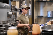 Airman 1st class Naiomi Vera Kelley, 5th Force Support Squadron food services team member, prepares steak during an internal cooking competition at the dining facility at Minot Air Force Base, North Dakota, Feb. 12, 2026. 5th Force Support Squadron food services Airmen created new dishes to expand dining facility menu options while improving their culinary skills. (U.S. Air Force photo by Airman Joseline Chacon Monterroso)