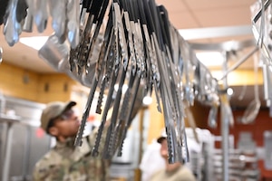 Serving tongs hang for use during an internal cooking competition at Minot Air Force Base, North Dakota, Feb. 12, 2026. Airmen assigned to the facility competed against one another to showcase their culinary skills and creativity while strengthening teamwork in the kitchen. (U.S. Air Force photo by Airman Joseline Chacon Monterroso)