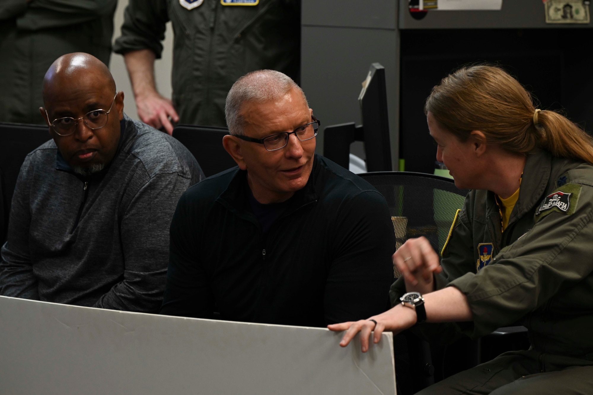 U.S. Air Force Lt. Col. Elizabeth Jarding, 37th Flying Training Squadron commander, and Chef Robert Irvine, Robert Irvine Foundation founder, discuss cockpit layout and pilot memory requirements while viewing a cockpit familiarization poster at the 37th FTS on Columbus Air Force Base, Mississippi, Feb. 27, 2026.
