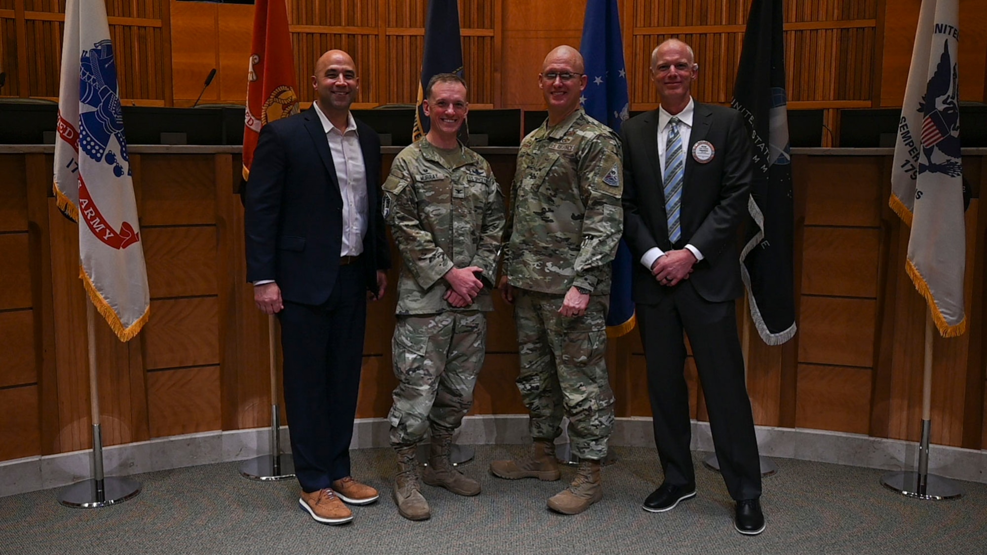 From left to right, Robert Devall, Aurora Chamber of Commerce director, U.S. Space Force Col. Eamon Murray, Space Base Delta 2 commander, U.S. Air Force Chief Master Sgt. Benjamin Johnson, SBD 2 senior enlisted airman, and Mr. Ryan Turbyfill, Rotary Club of Aurora president, pose for a photo following the 25th annual State of the Base address in Aurora, Colorado, March 12, 2026.