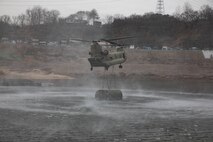 U.S. Army pilots assigned to the 2nd Combat Aviation Brigade, 2d Infantry Division/ROK-US Combined Division, fly a CH-47 Chinook unloading a M30 Bridge Erecting Boat during a wet gap crossing exercise as part of Freedom Shield near Yeoncheon, South Korea, Mar. 14, 2026.