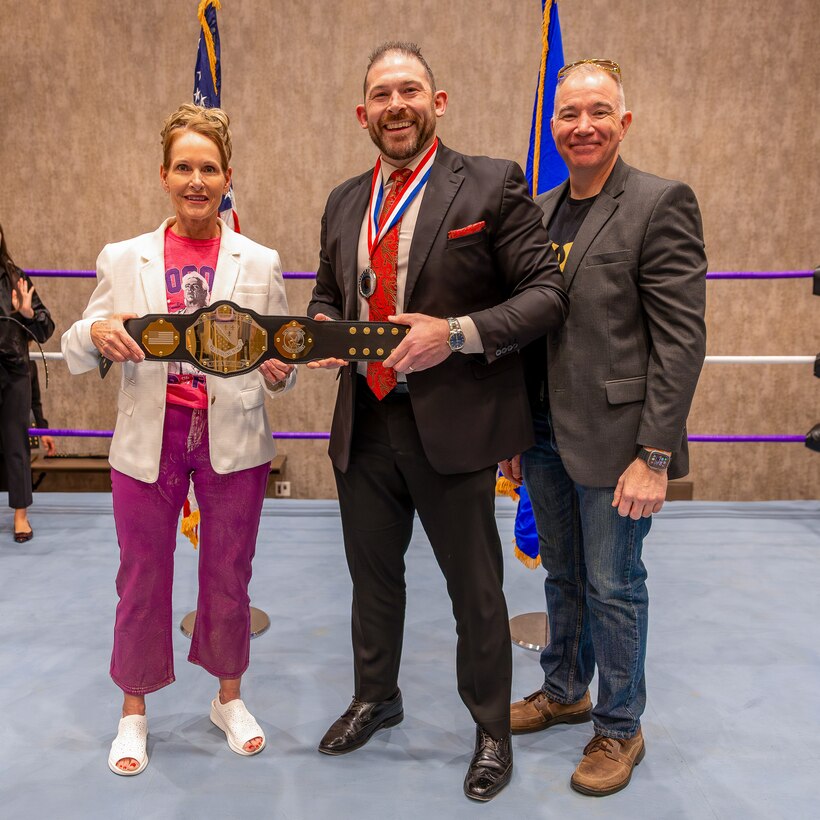Michael Battaglino, 82nd Training Support Squadron faculty development chief, receives the Civilian Supervisory Category 3 of the Year Award from U.S. Air Force Col. Kellie Courtland, left, 82nd Training Wing deputy commander, and U.S. Air Force Chief Master Sgt. Rey Schultz, right, 82nd TRW command chief, during the 2025 Annual Awards Banquet in Wichita Falls, Texas, Feb. 27, 2026.