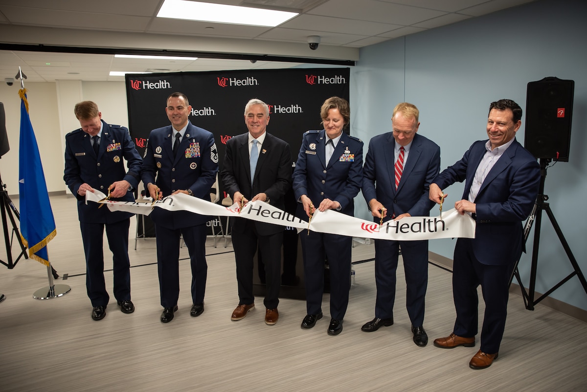 From left: Brig. Gen. Robert Bogart, commander of the 711th Human Performance Wing; Chief Master Sgt. James Woods, medical enlisted force and enlisted corps chief, Office of the Surgeon General; Brad Wenstrup, former U.S. Rep. of Ohio; Col. Valerie Sams, director of the Center for Sustainment of Trauma and Readiness Skills (C-STARS) Cincinnati, U.S. Air Force, and trauma surgeon at University of Cincinnati (UC) Medical Center; Dr. Greg Postel, dean of the UC College of Medicine; and Cory Shaw, president and CEO of UC Health, cut the ribbon during an opening ceremony for the expanded C-STARS Cincinnati DARRIO Simulation Center at UC Medical Center in Cincinnati, Ohio, March 11, 2026. C-STARS Cincinnati is a joint program between UC Health and the U.S. Air Force that provides advanced trauma and critical care training for military medical personnel. The program’s new simulation center represented the next generation of military trauma training, medical readiness, response and research capabilities. (U.S. Air Force photo by Ryan Law)