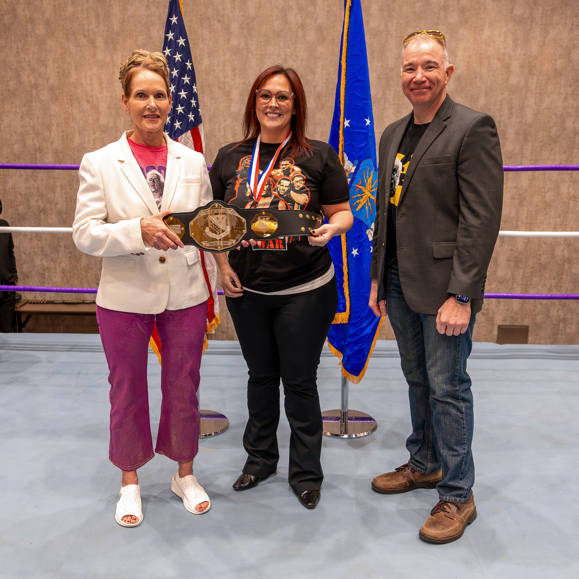 Nikkita Barr, 82nd Training Group executive officer, receives the Technical Training Support Civilian, Non‑Supervisory, Category 2, of the Year Award from U.S. Air Force Col. Kellie Courtland, left, 82nd Training Wing deputy commander, and U.S. Air Force Chief Master Sgt. Rey Schultz, right, 82nd TRW command chief, during the 2025 Annual Awards Banquet in Wichita Falls, Texas, Feb. 27, 2026.
