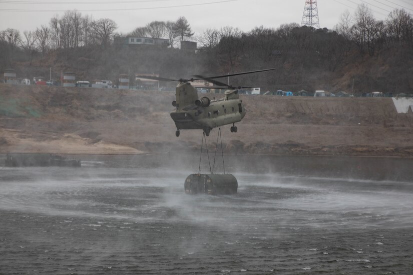 U.S. Army pilots assigned to the 2nd Combat Aviation Brigade, 2d Infantry Division/ROK-US Combined Division, fly a CH-47 Chinook unloading a M30 Bridge Erecting Boat during a wet gap crossing exercise as part of Freedom Shield near Yeoncheon, South Korea, Mar. 14, 2026.