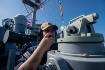 Quartermaster 2nd Class Soledh Rivera uses a sound-powered telephone aboard U.S. 7th Fleet flagship USS Blue Ridge (LCC 19) as the ship prepares to enter port in Manila, Philippines, March 16, 2026.