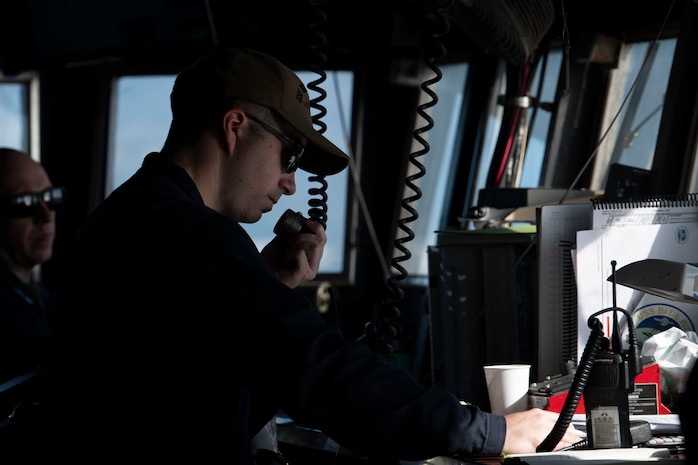 Lt. j.g. Jonah Cranford communicates over the bridge-to-bridge radio on the bridge of U.S. 7th Fleet flagship USS Blue Ridge (LCC 19) as the ship prepares to enter port in Manila, Philippines, March 16, 2026.