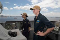 Ensign Ayana Bullock, left, and Ensign Chance Sylvester look out from the bridge wing aboard U.S. 7th Fleet flagship USS Blue Ridge (LCC 19) as the ship prepares to enter port in Manila, Philippines, March 16, 2026.