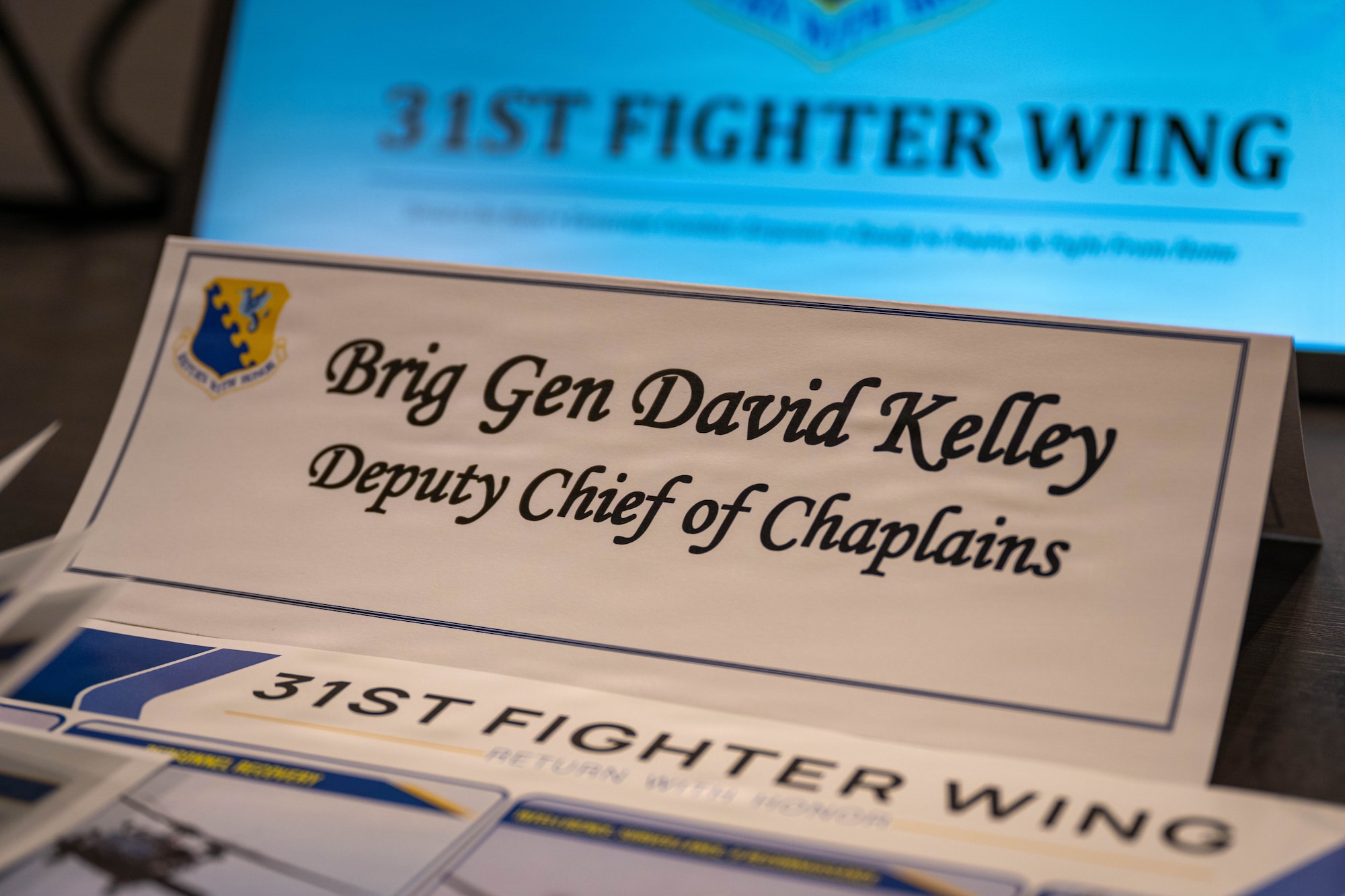 A name card is placed on a table.