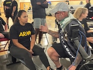 U.S. Army Staff Sgt. Mercedes Rangel listens to her coach before participating in the rowing event at the Army Recovery Care Program’s Army Trials, at Fort Bliss, Texas, Feb. 25 - March 5.