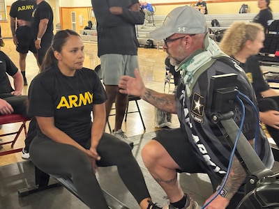 U.S. Army Staff Sgt. Mercedes Rangel listens to her coach before participating in the rowing event at the Army Recovery Care Program’s Army Trials, at Fort Bliss, Texas, Feb. 25 - March 5.