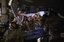 airmen and other service members watch a load demo