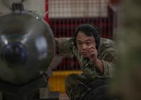airmen align munition during a load demo
