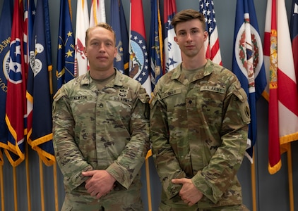 Staff Sgt. Newton and Spc. Cooper pose after winning the Best Warrior Competition