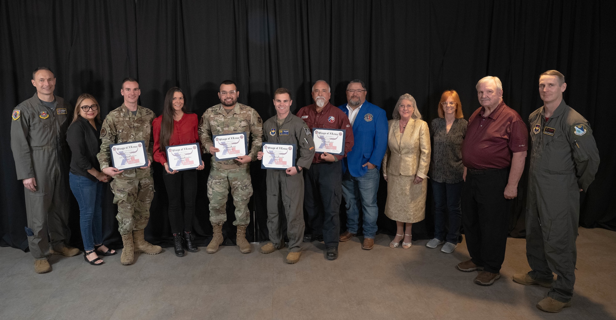 U.S. Air Force Airmen assigned to the 47th Flying Training Wing and members of the Del Rio Military Affairs Association come together for a group photo during the Wings of XLence Luncheon at Laughlin Air Force Base, Texas, March 13, 2026. The Wings of XLence luncheon served as an opportunity to recognize the top quarterly performers in each group and strengthen the ties between Laughlin and the local community. (U.S. Air Force photo by Airman 1st Class Darryl Keith)