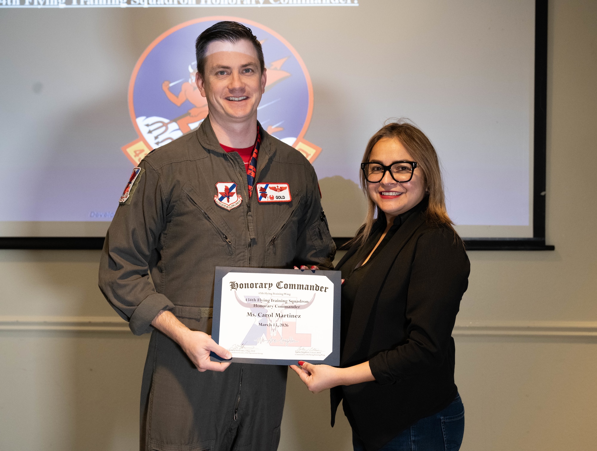 U.S. Air Force Lt. Col. Bendel Rushing, 434th Flying Training Squadron commander, presents an honorary commander certificate to Carol Martinez, 434 FTS honorary commander, during the Wings of XLence luncheon at Laughlin Air Force Base, Texas, March 13, 2026. The honorary commander program enables community members to understand Laughlin’s mission by pairing local civic leaders with unit leadership. (U.S. Air Force photo by Airman 1st Class Darryl Keith)