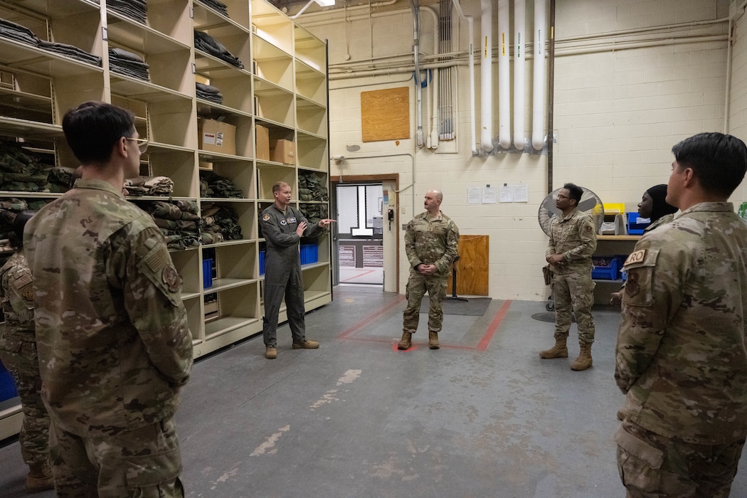 U.S. Air Force Col. Richard Kind, 97th Air Mobility Wing (AMW) commander, and Chief Master Sgt. Jonny Adams, 97th AMW command chief, talk with members of the 97th Logistics Readiness Squadron (LRS) at Altus Air Force Base, Oklahoma, Feb. 25, 2026. As a part of the 97th AMW command team’s hands-on immersion tour with the 97th LRS, they took part in an interactive discussion with members of the Individual Protective Equipment team which fostered collaboration and strengthened their understanding of the 97th LRS operations.  (U.S. Air Force photo by Airman 1st Class Emma Wright)