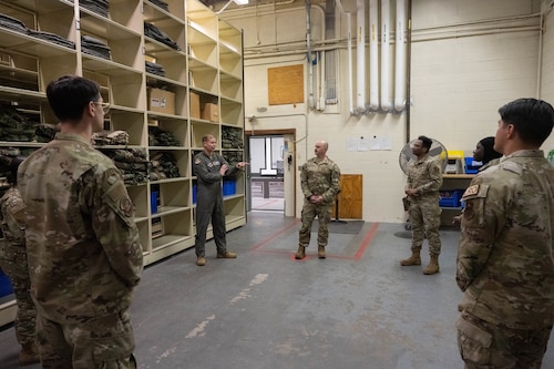 U.S. Air Force Col. Richard Kind, 97th Air Mobility Wing (AMW) commander, and Chief Master Sgt. Jonny Adams, 97th AMW command chief, talk with members of the 97th Logistics Readiness Squadron (LRS) at Altus Air Force Base, Oklahoma, Feb. 25, 2026. As a part of the 97th AMW command team’s hands-on immersion tour with the 97th LRS, they took part in an interactive discussion with members of the Individual Protective Equipment team which fostered collaboration and strengthened their understanding of the 97th LRS operations.  (U.S. Air Force photo by Airman 1st Class Emma Wright)