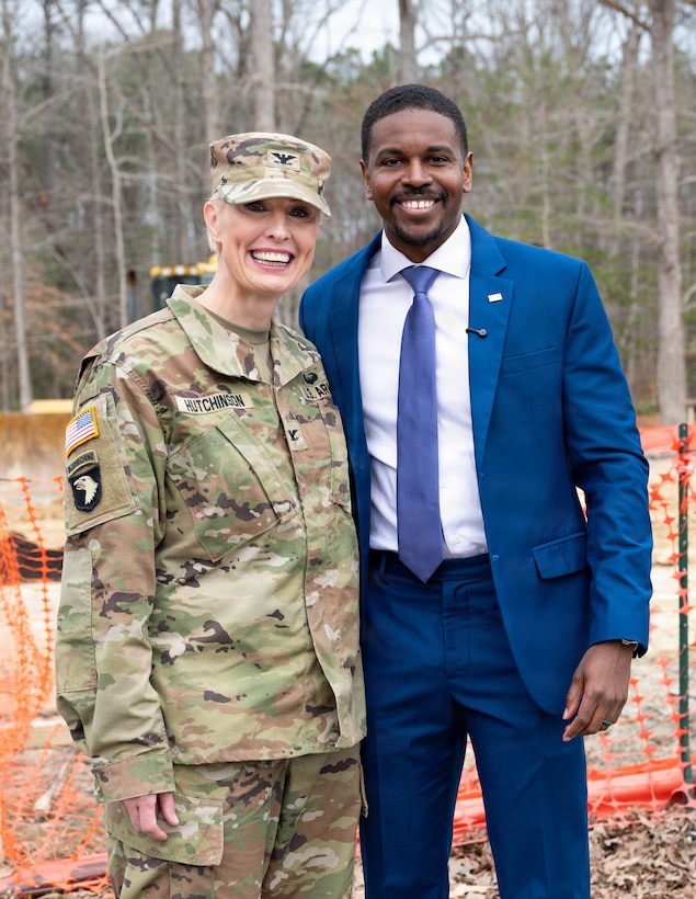U.S. Army Col. Laura Hutchinson stands to the left of Phillip Jones, and they smile for a photo together.