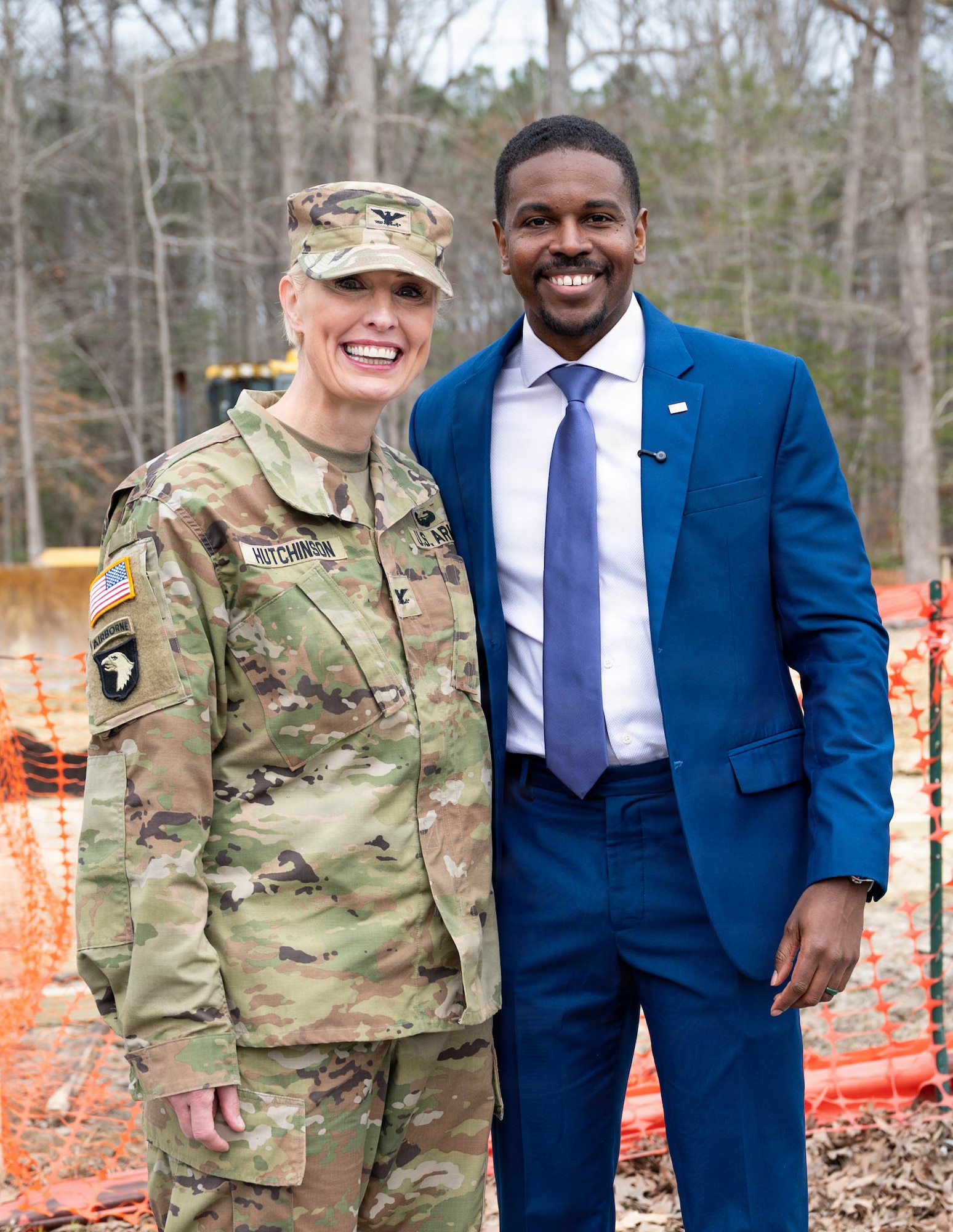 U.S. Army Col. Laura Hutchinson stands to the left of Phillip Jones, and they smile for a photo together.