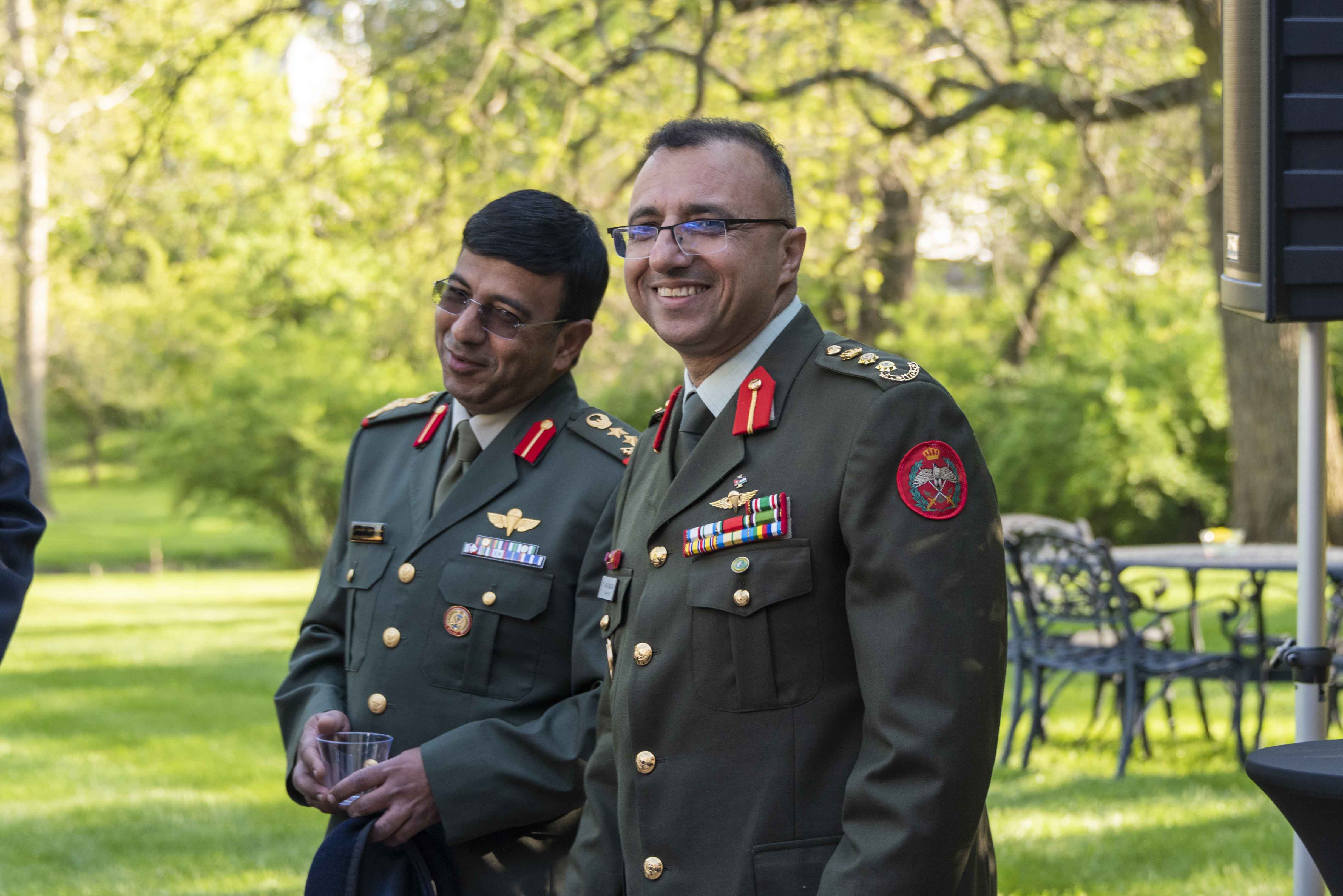 Two international fellow students smiling together outside.