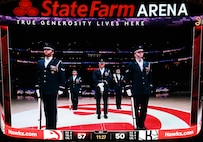 A jumbotron shows the U.S. Air Force Honor Guard Drill Team as they perform during an NBA halftime show in Atlanta, Ga., March 12, 2026. During the event the Drill Team performed in front of approximately 16,000 guests and emphasized the team mission of connecting with audiences and inspiring the next generation of service members through precision and excellence. (U.S. Air Force photo by Tech. Sgt. Sergio A. Gamboa)