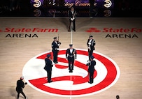The U.S. Air Force Honor Guard Drill Team performs a weapons drill routine during an NBA halftime show in Atlanta, Ga., March 12, 2026. The Drill Team traveled to Georgia to perform for five high schools, a community event, and during a halftime show for the Atlanta Hawks vs. Brooklyn Nets basketball game to showcase the Air Force’s precision and excellence. (U.S. Air Force photo by Tech. Sgt. Sergio A. Gamboa)