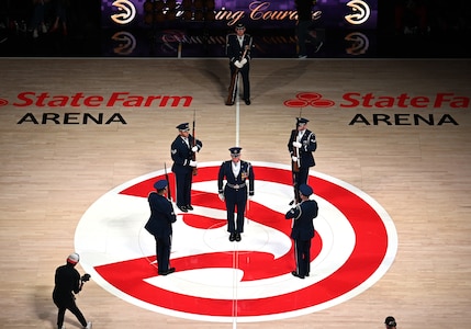 The U.S. Air Force Honor Guard Drill Team performs a weapons drill routine during an NBA halftime show in Atlanta, Ga., March 12, 2026. The Drill Team traveled to Georgia to perform for five high schools, a community event, and during a halftime show for the Atlanta Hawks vs. Brooklyn Nets basketball game to showcase the Air Force’s precision and excellence. (U.S. Air Force photo by Tech. Sgt. Sergio A. Gamboa)