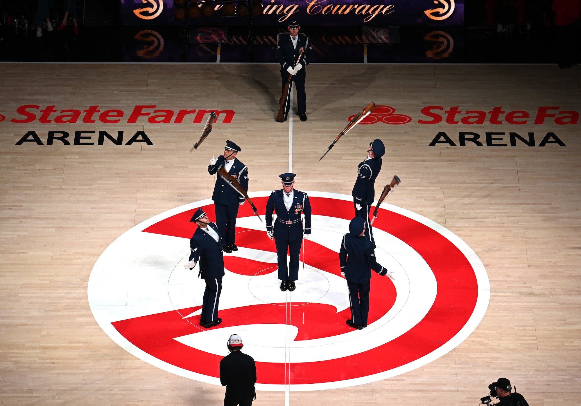 The U.S. Air Force Honor Guard Drill Team performs a weapons drill routine during an NBA halftime show in Atlanta, Ga., March 12, 2026. The Drill Team traveled to Georgia to perform for five high schools, a community event, and during a halftime show for the Atlanta Hawks vs. Brooklyn Nets basketball game to showcase the Air Force’s precision and excellence. (U.S. Air Force photo by Tech. Sgt. Sergio A. Gamboa)