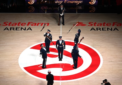 The U.S. Air Force Honor Guard Drill Team performs a weapons drill routine during an NBA halftime show in Atlanta, Ga., March 12, 2026. The Drill Team traveled to Georgia to perform for five high schools, a community event, and during a halftime show for the Atlanta Hawks vs. Brooklyn Nets basketball game to showcase the Air Force’s precision and excellence. (U.S. Air Force photo by Tech. Sgt. Sergio A. Gamboa)