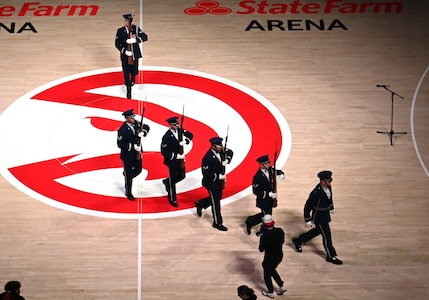 The U.S. Air Force Honor Guard Drill Team exits the Atlanta Hawks basketball court after an NBA halftime show in Atlanta, Ga., March 12, 2026. The team performed a four-man drill that showcased precision, excellence and discipline in front of approximately 16,000 guests during a military appreciation night. (U.S. Air Force photo by Tech. Sgt. Sergio A. Gamboa)