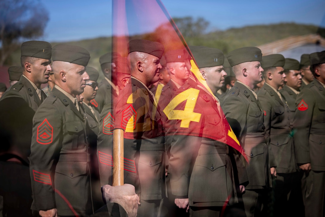 U.S. Marines with 2nd Battalion, 4th Marine Regiment, 1st Marine Division, stand at attention during the Battalion Landing Team 2/4 composite ceremony at Marine Corps Base Camp Pendleton, California, March 12, 2026. The ceremony was held to recognize the battalion’s transition to a battalion landing team and subsequent composite under the 13th Marine Expeditionary Unit, I Marine Expeditionary Force. (U.S. Marine Corps photo illustration by Cpl. Mary R. Jenni) (This image was made in camera using double exposure with a Canon R5-C.)
