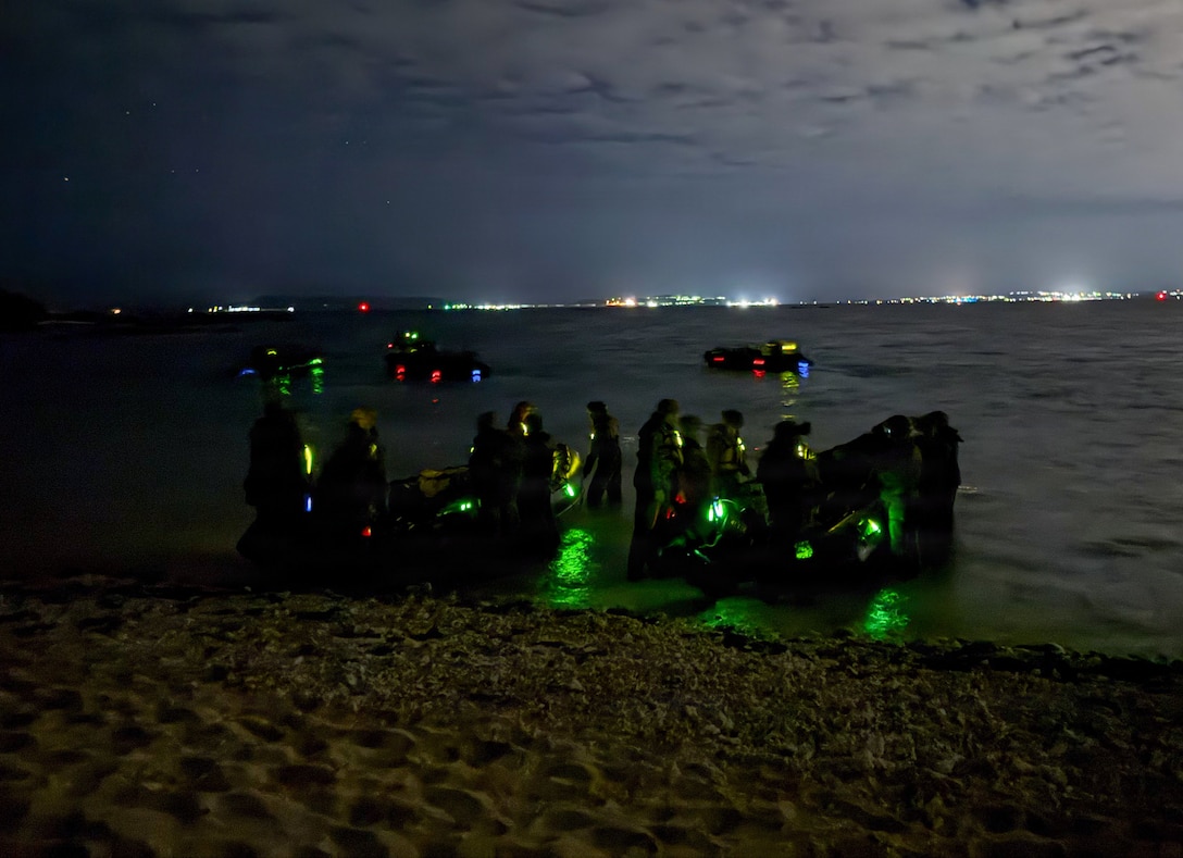 U.S. Marines with India Company, Battalion Landing Team 3rd Battalion, 1st Marine Regiment, 31st Marine Expeditionary Unit, come to shore during a night raid at Kin Blue Training Area, Okinawa, Japan, Feb. 15, 2025. This training aimed to enhance the ability to conduct boat raids using the newly fielded enhanced combat rubber reconnaissance craft. The 31st MEU is a persistent, combat credible force operating aboard the ships of the Tripoli Amphibious Ready Group in the U.S. 7th Fleet area of operations, routinely interacting and operating with our allies and partners to contribute to deterrence, security, crisis response, and combat operations in the Indo-Pacific region. (U.S. Marine Corps photo by Cpl. Rebeka Falcon)