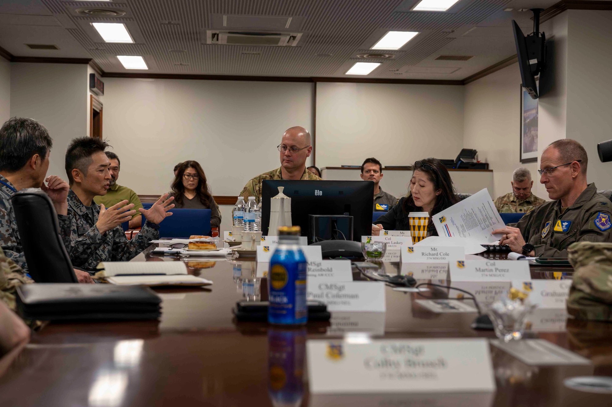 Military members sit at a table.