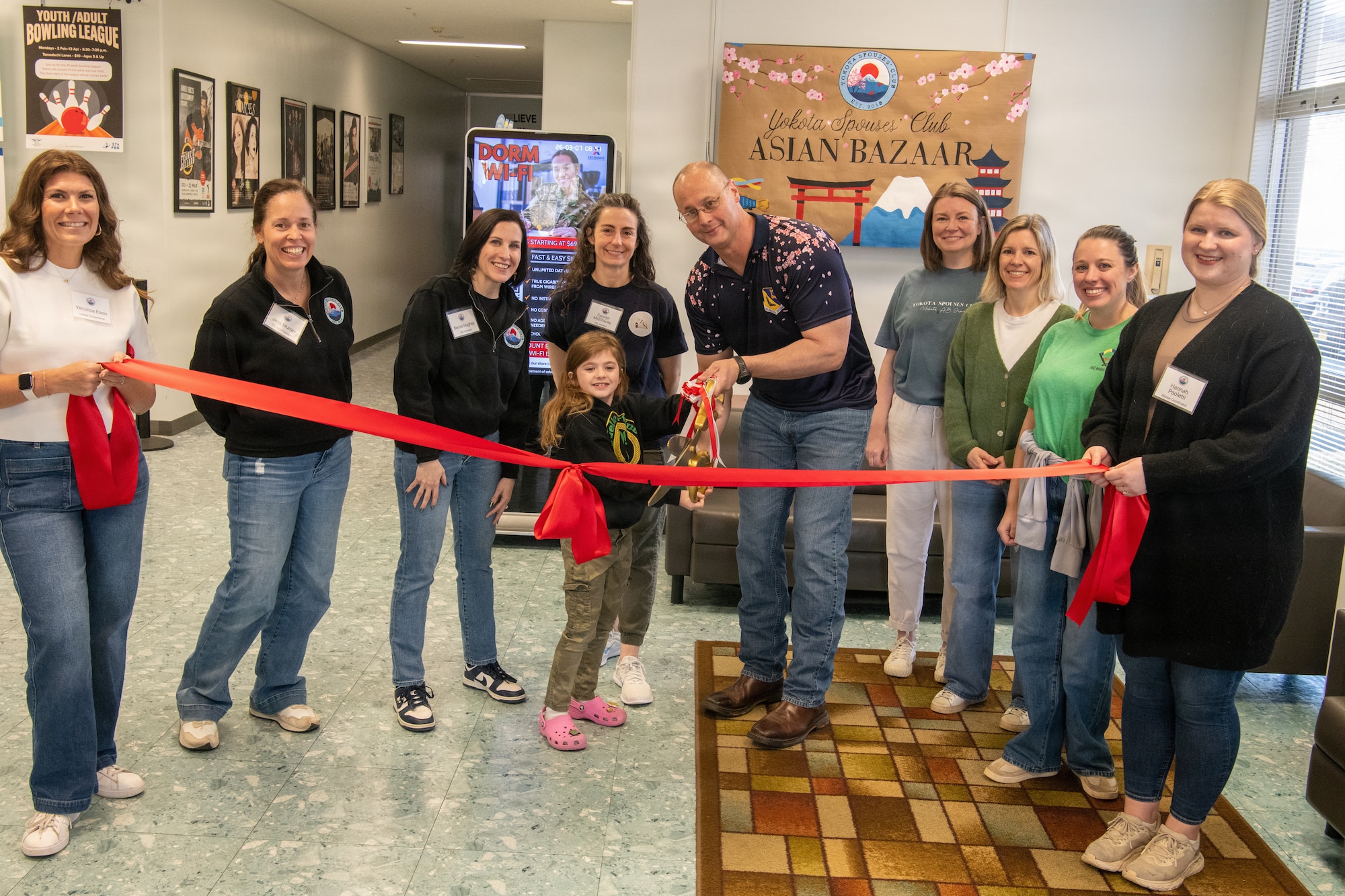 Yokota Spouses' Club and the 374th Airlift Wing Commander cut a ribbon.