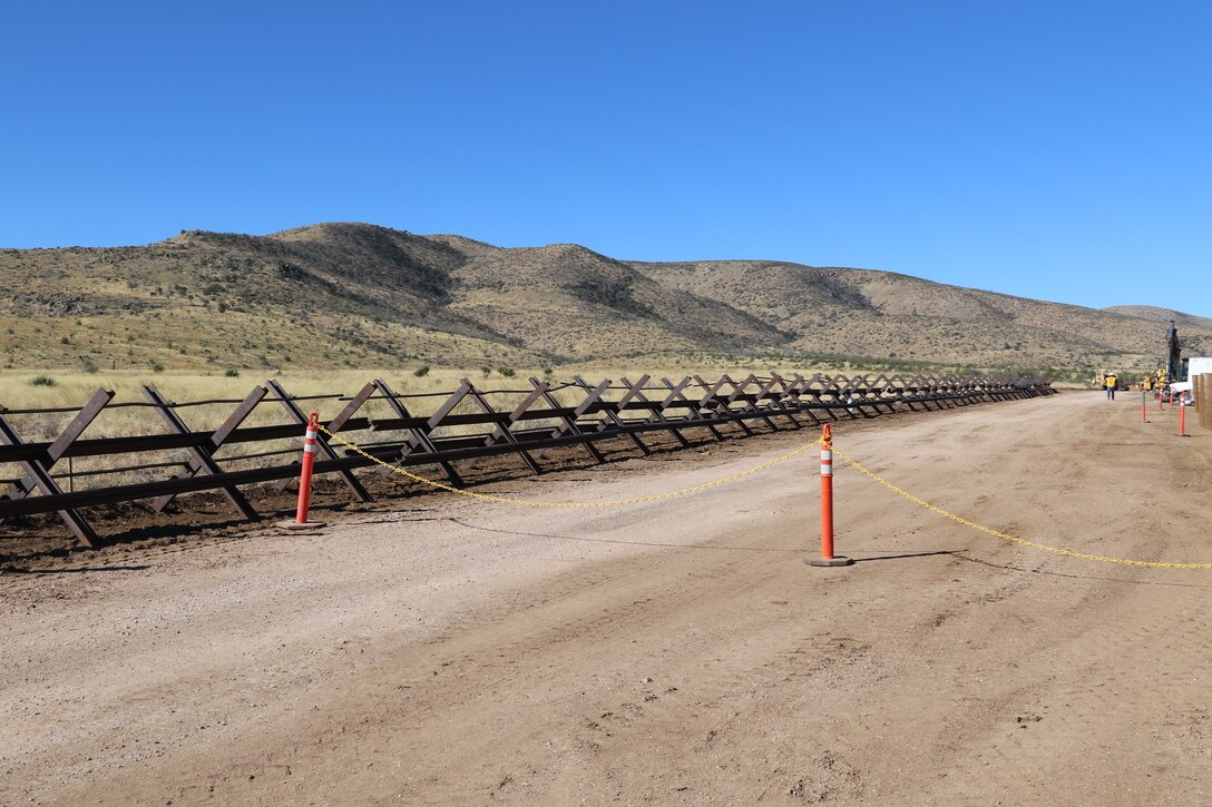 South Pacific Border Task Force contractors prepare to remove outdated fencing and older railings before installing new bollard-style barrier panels at the National Defense Area One, or NDA-1, project site March 3 near Antelope Wells, New Mexico. The NDA-1 project consists of installation of up to six miles of new permanent border barrier with access gates, patrol roadways and access improvements through the Roosevelt Reservation Corridor in Hildago County. USACE is installing border barriers along the southern border of the U.S. at the direction of the U.S. Army by the Secretary of War, in response to the presidential national emergency declaration, dated Jan. 20, 2025, authorizing the use of Section 2808 of Title 10, U.S. Code.