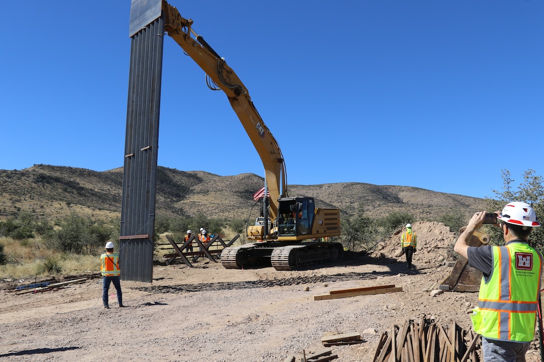 Mike Tuttle, a project manager assigned to the South Pacific Border Task Force, U.S. Army Corps of Engineers, records the first panel installation at the National Defense Area One, or NDA-1, project site March 3 near Antelope Wells, New Mexico. USACE is installing border barriers along the southern border of the U.S. at the direction of the U.S. Army by the Secretary of War, in response to the presidential national emergency declaration, dated Jan. 20, 2025, authorizing the use of Section 2808 of Title 10, U.S. Code. (No one in this image crossed the international border) (Photo by Robert DeDeaux, USACE Los Angeles District Public Affairs)
