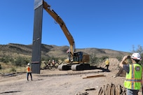 Mike Tuttle, a project manager assigned to the South Pacific Border Task Force, U.S. Army Corps of Engineers, records the first panel installation at the National Defense Area One, or NDA-1, project site March 3 near Antelope Wells, New Mexico. USACE is installing border barriers along the southern border of the U.S. at the direction of the U.S. Army by the Secretary of War, in response to the presidential national emergency declaration, dated Jan. 20, 2025, authorizing the use of Section 2808 of Title 10, U.S. Code. (No one in this image crossed the international border) (Photo by Robert DeDeaux, USACE Los Angeles District Public Affairs)