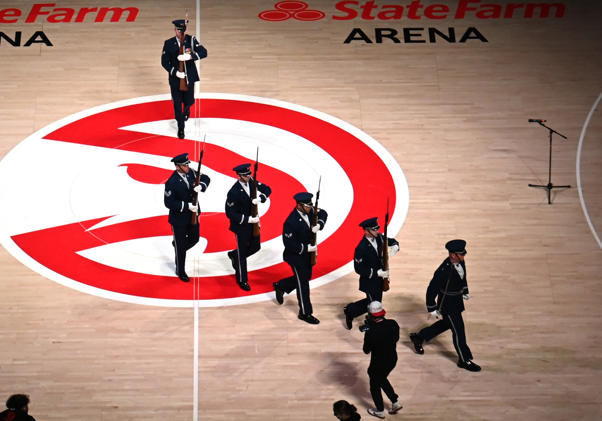 The U.S. Air Force Honor Guard Drill Team exits the Atlanta Hawks basketball court after an NBA halftime show in Atlanta, Ga., March 12, 2026. The team performed a four-man drill that showcased precision, excellence and discipline in front of approximately 16,000 guests during a military appreciation night. (U.S. Air Force photo by Tech. Sgt. Sergio A. Gamboa)