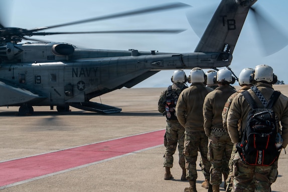 U.S. Air Force Airmen, assigned to the 8th Medical Group, prepare to board a U.S. Navy MH-53E Sea Dragon helicopter during a medical evacuation training as part of exercise Freedom Shield 26 at Kunsan Air Base, Republic of Korea, March 10, 2026. The exercise presents participants with realistic threat scenarios to strengthen shared understanding and combined defense capabilities. (U.S. Air Force photo by Staff Sgt. Cedrique Oldaker)